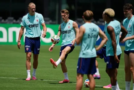 Martin Ødegaard juggles a ball as Erling Haaland looks on during Norway training in Miami.