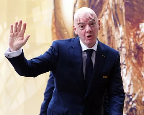 Gianni Infantino waving to reporters on the day of the World Cup final