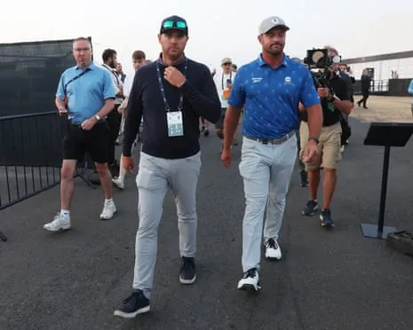 Bryson DeChambeau with his agent Brett Falkoff after handing in his card